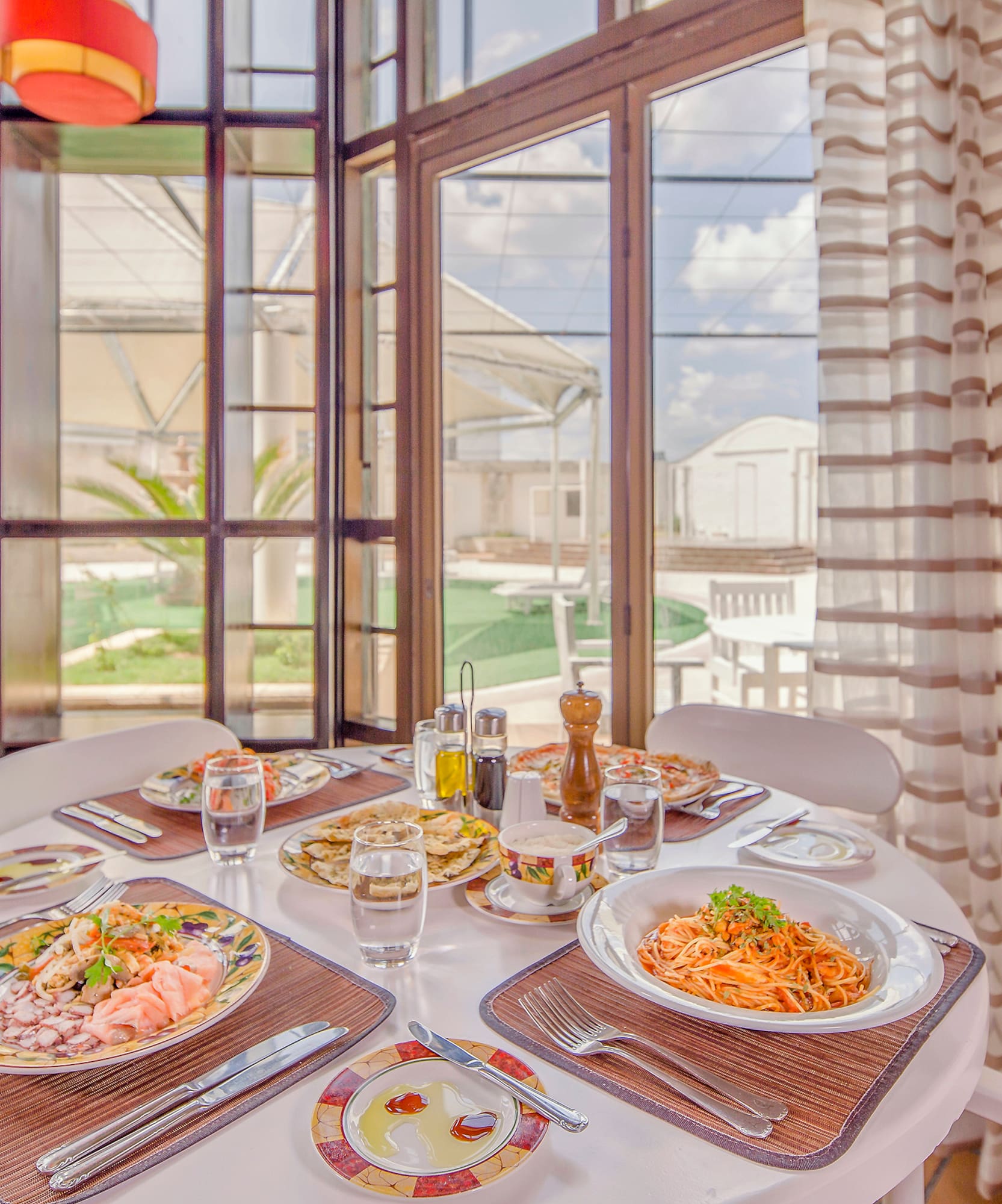 a table with plates of food and glasses on it