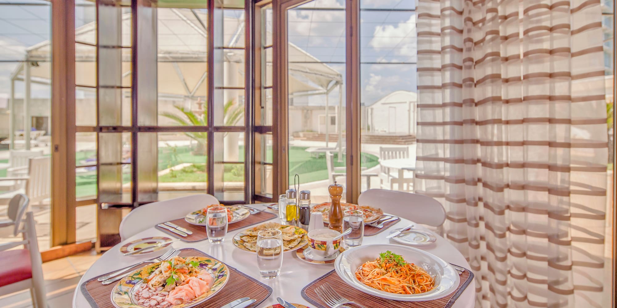 a table with plates of food and glasses on it