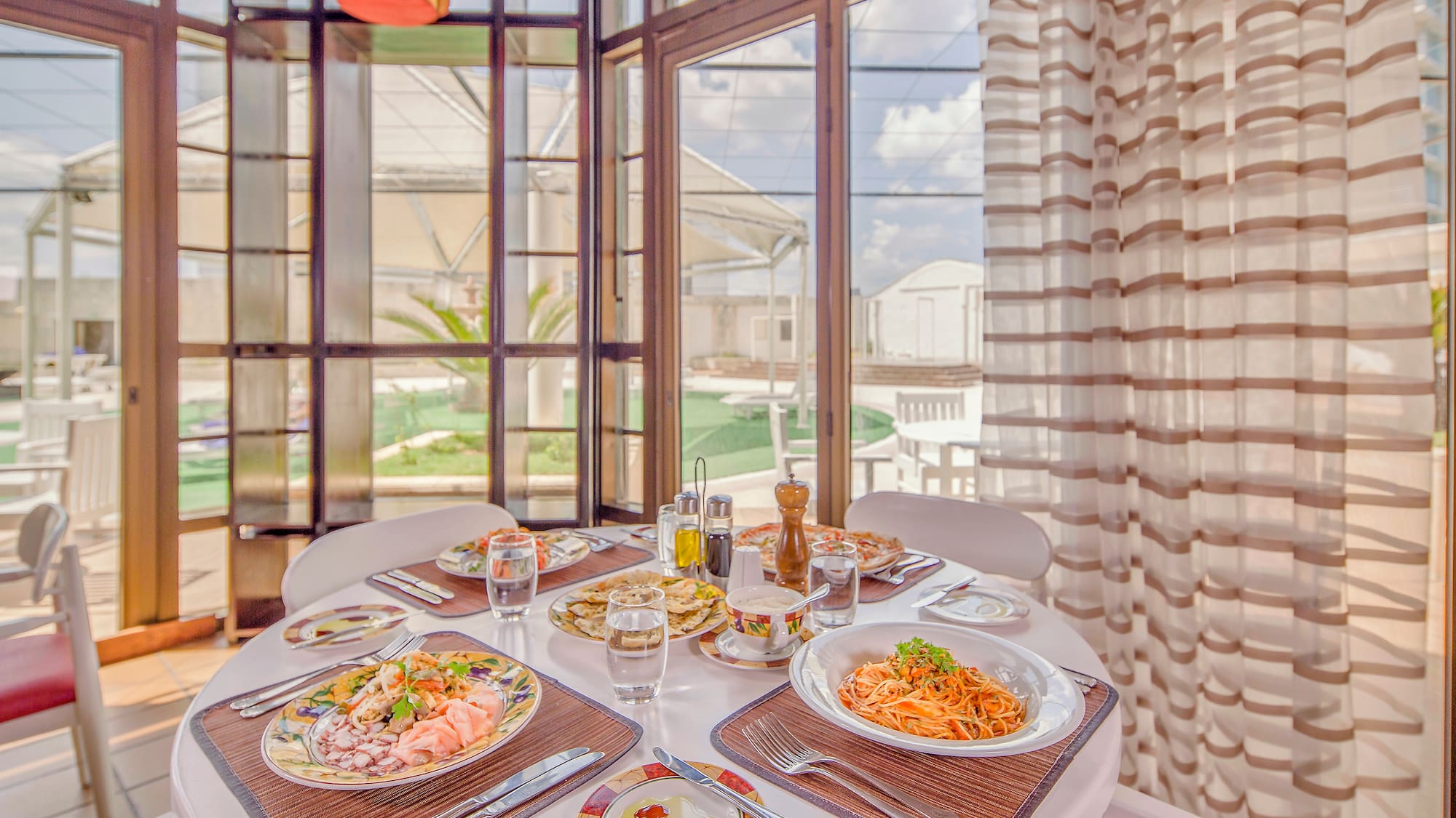 a table with plates of food and glasses on it