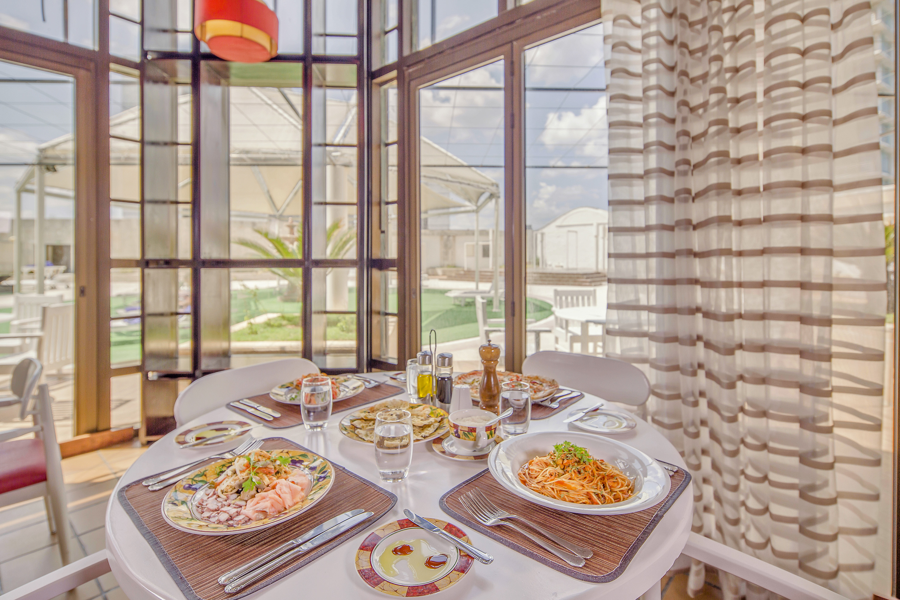 a table with plates of food and glasses on it