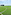Artificial turf soccer field with white lines, goal, floodlights, and sea view.
