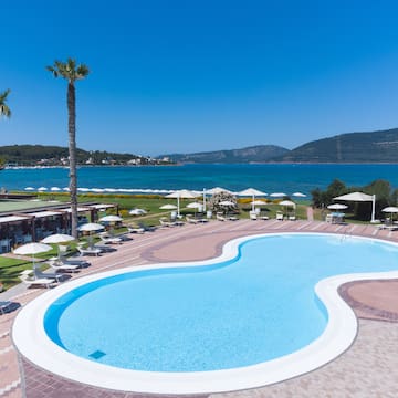 a pool with a beach and palm trees