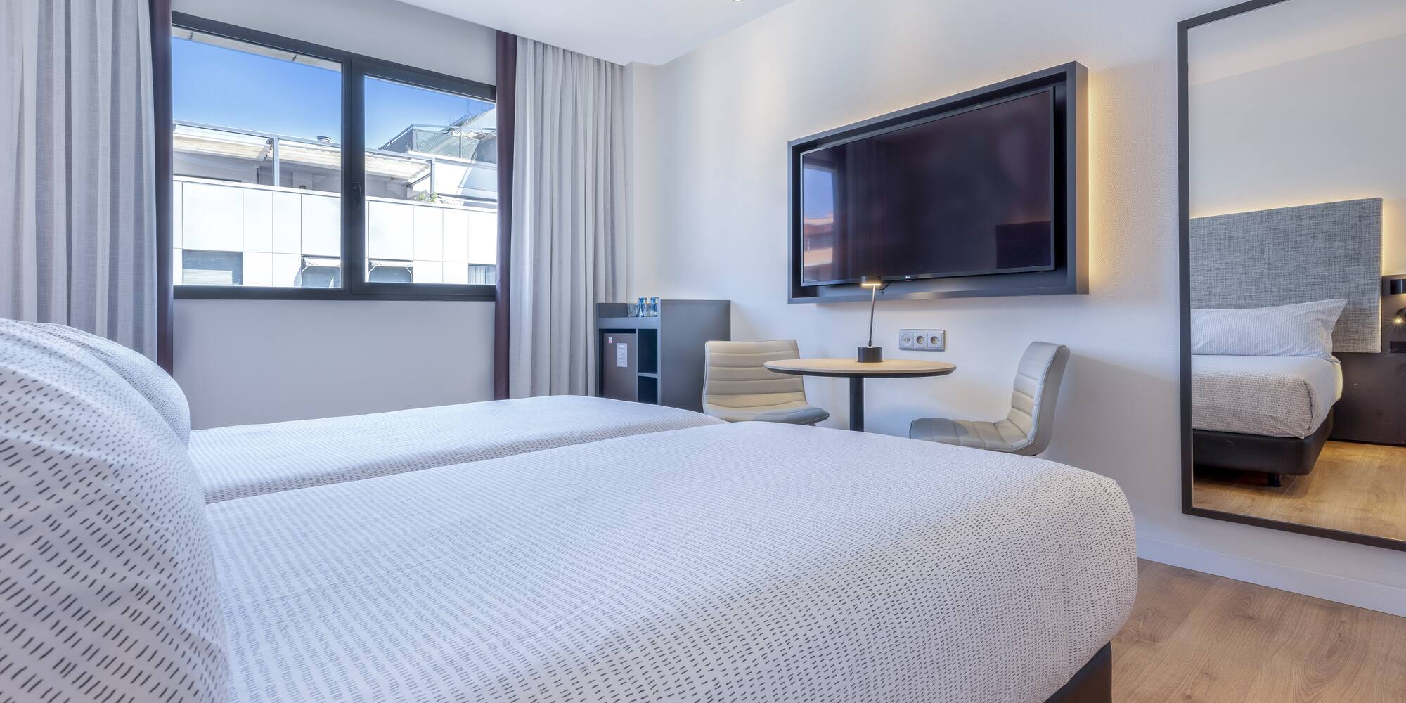 a room with two beds and a tv