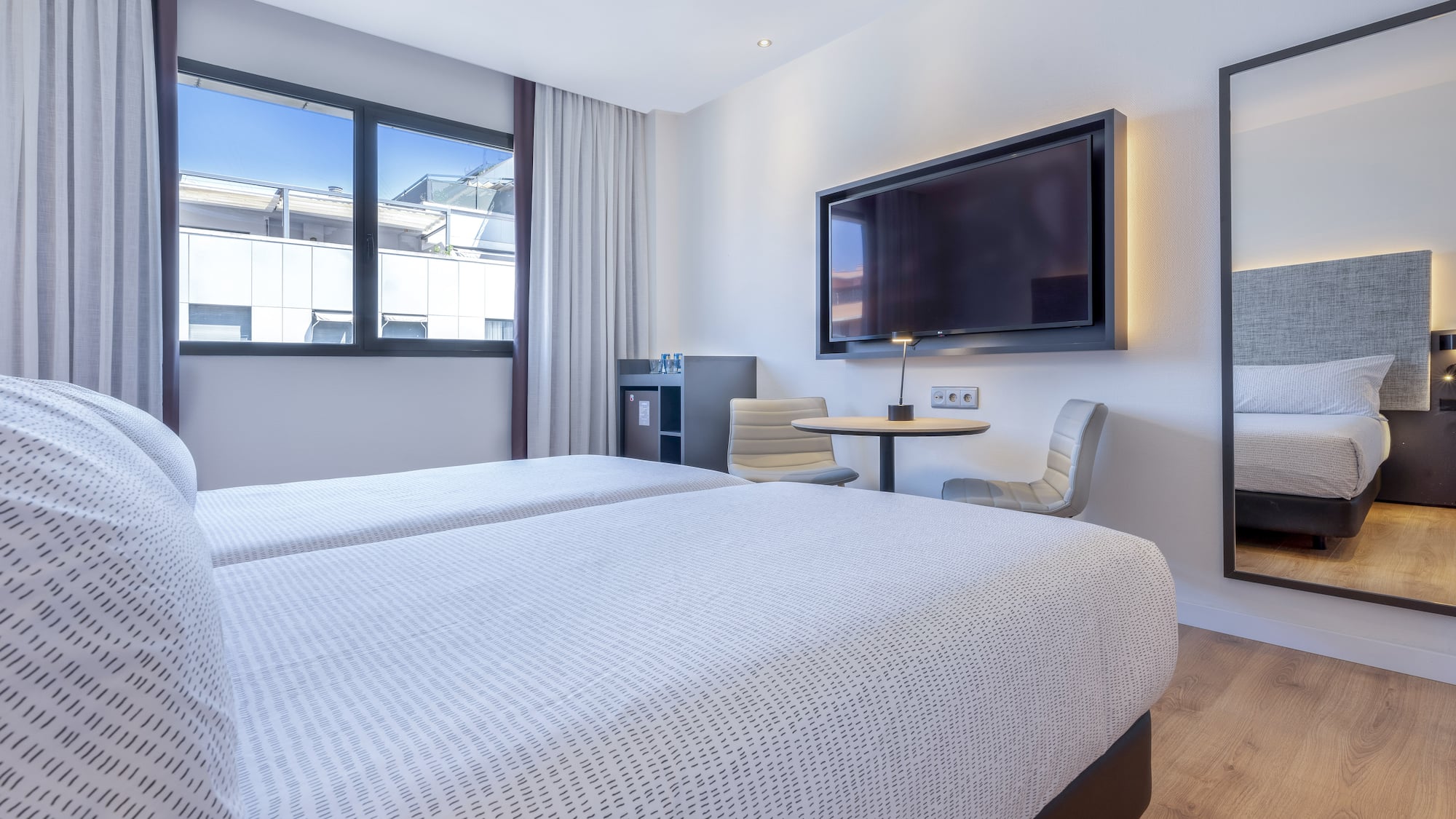 a room with two beds and a tv