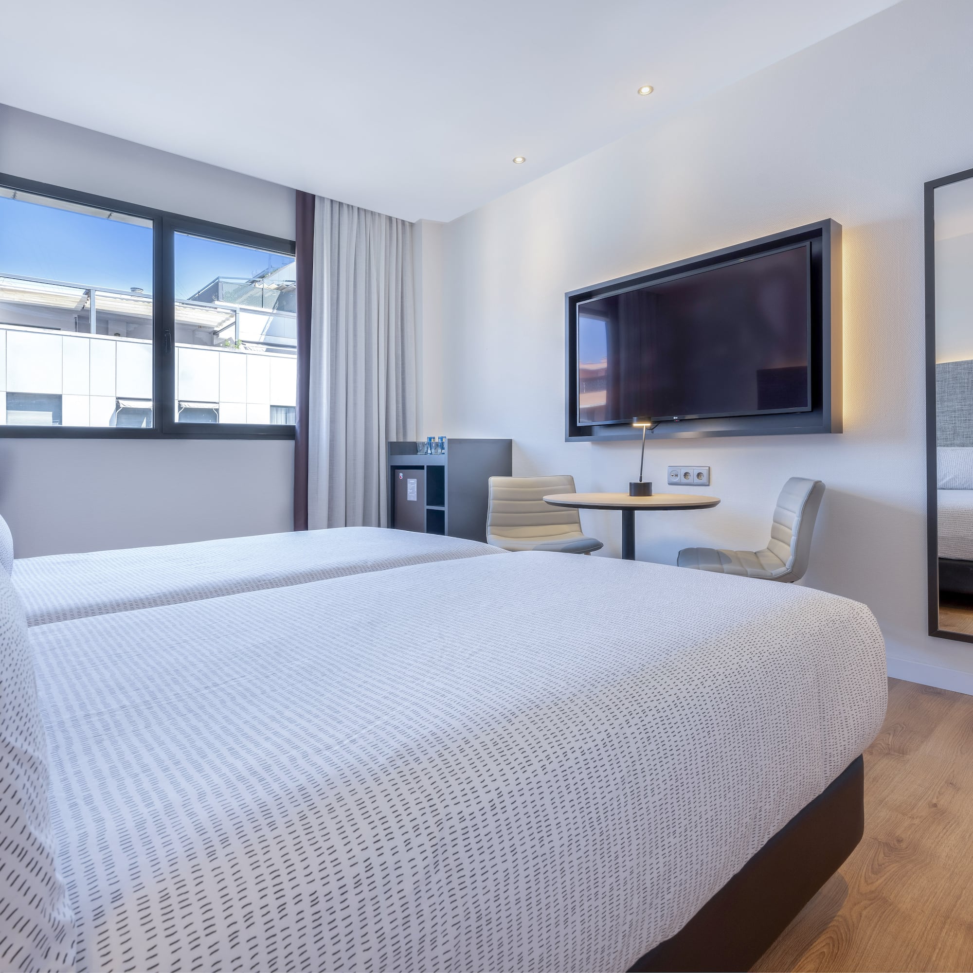 a room with two beds and a tv