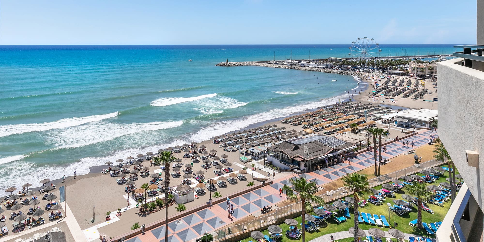 a beach with many chairs and umbrellas