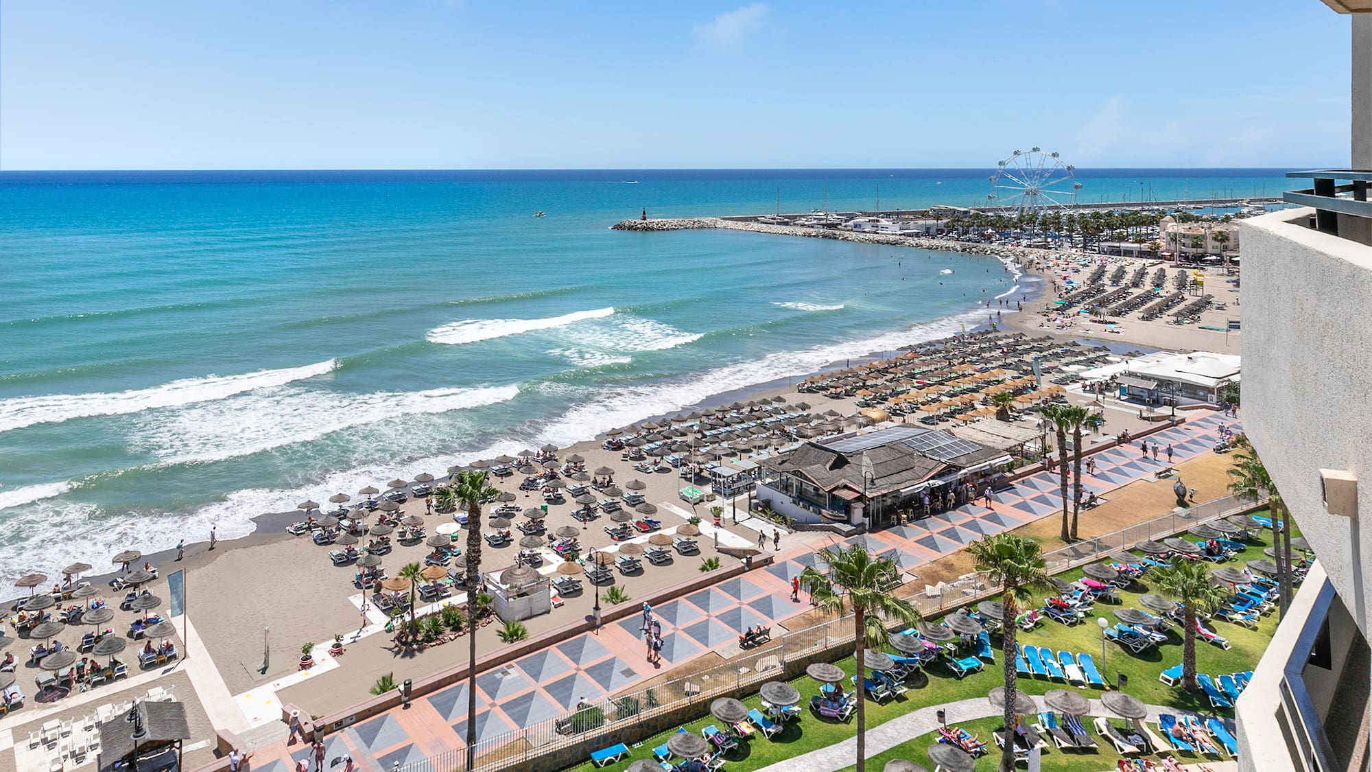 a beach with many chairs and umbrellas