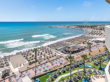 a beach with many chairs and umbrellas