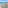 Crowded beach resort, blue ocean waves, marina, Ferris wheel, and promenade.