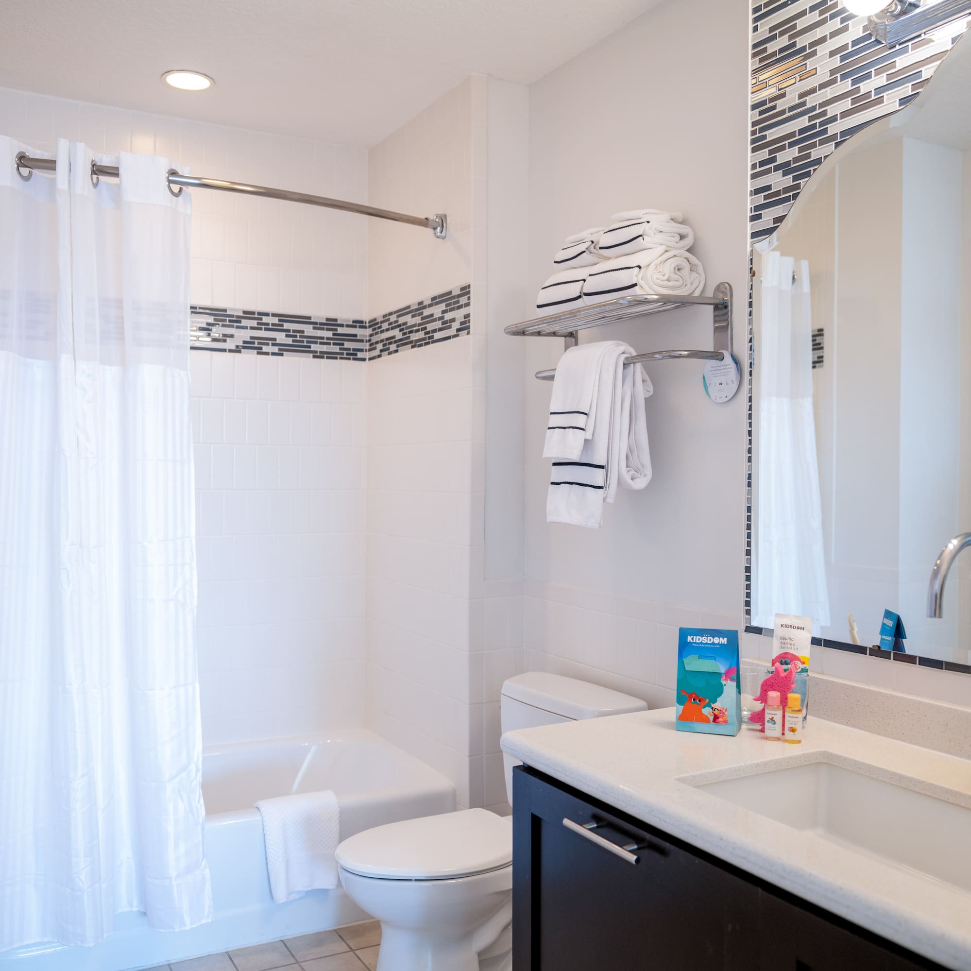 a bathroom with a sink toilet and shower curtain