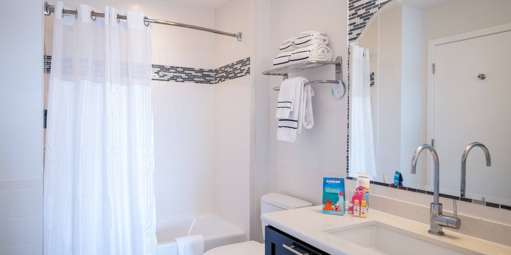 a bathroom with a sink toilet and shower curtain