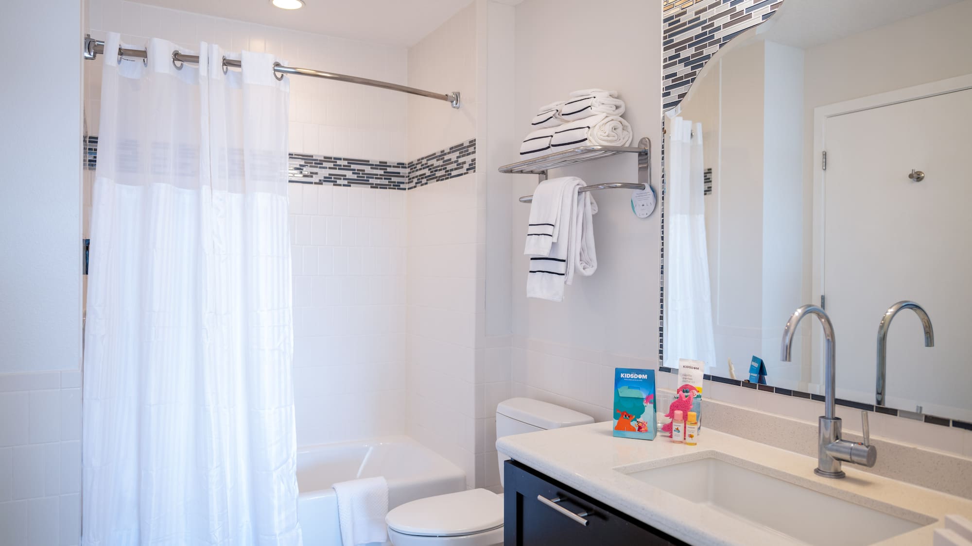 a bathroom with a sink toilet and shower curtain