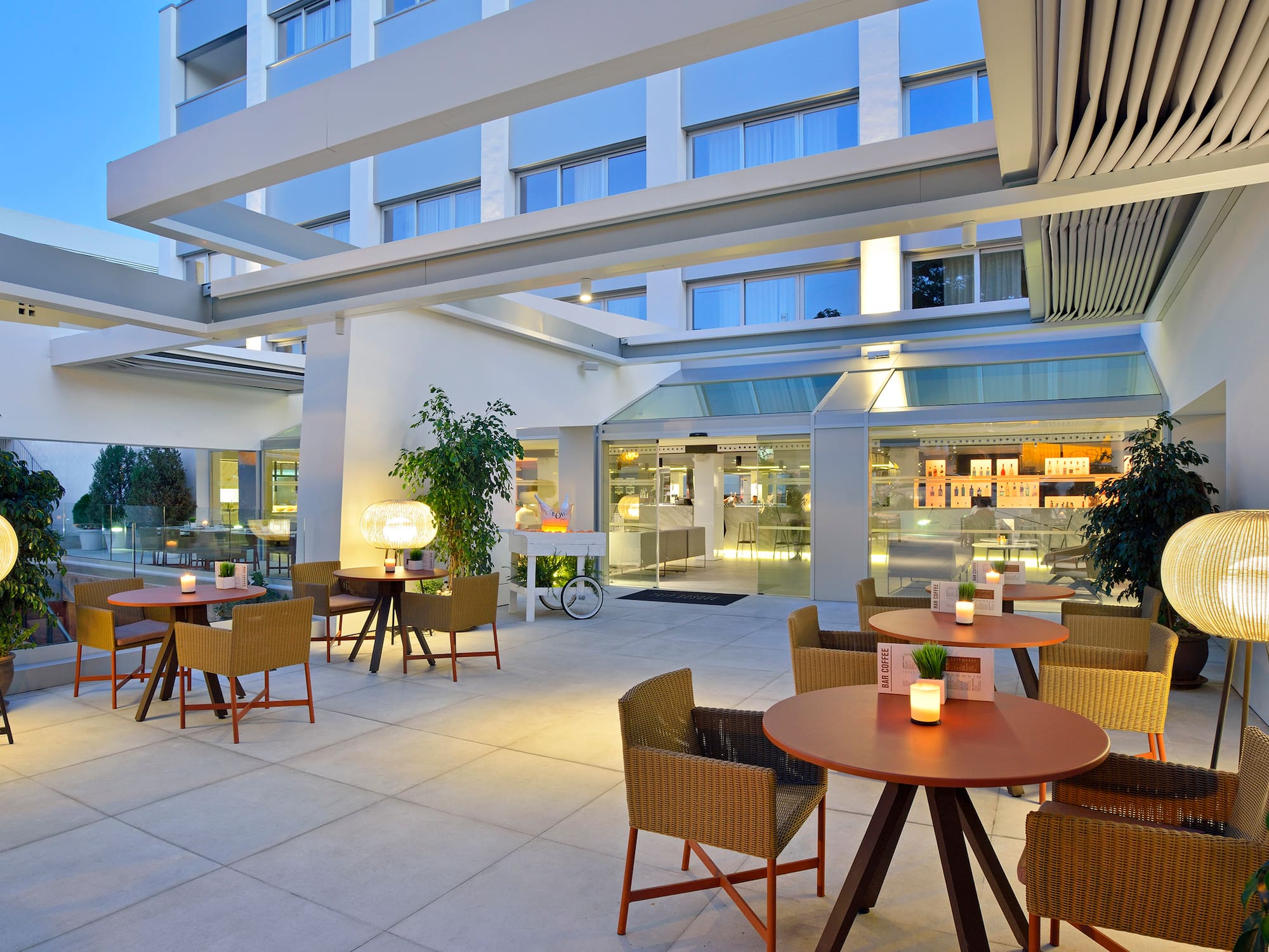 a patio with tables and chairs