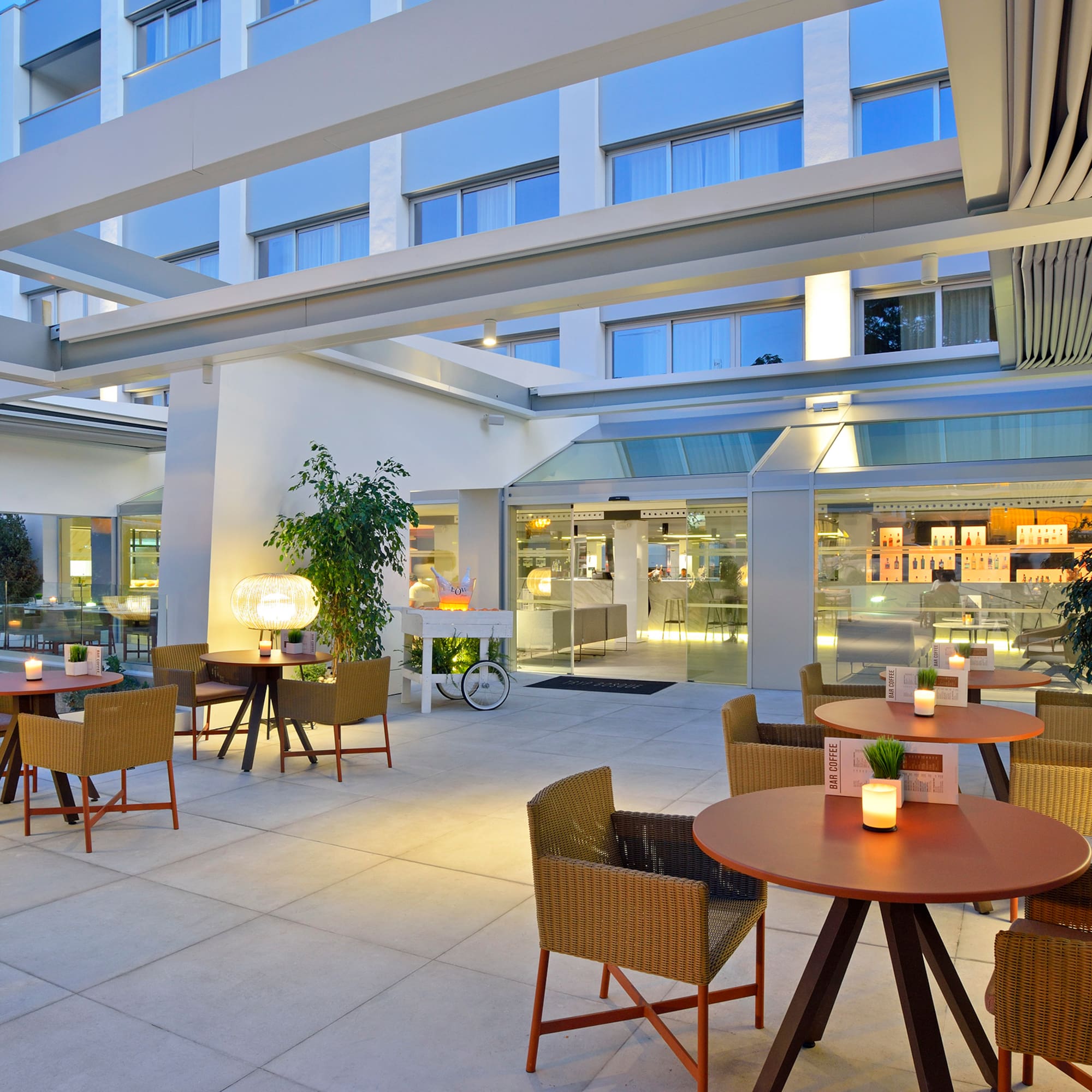 a patio with tables and chairs