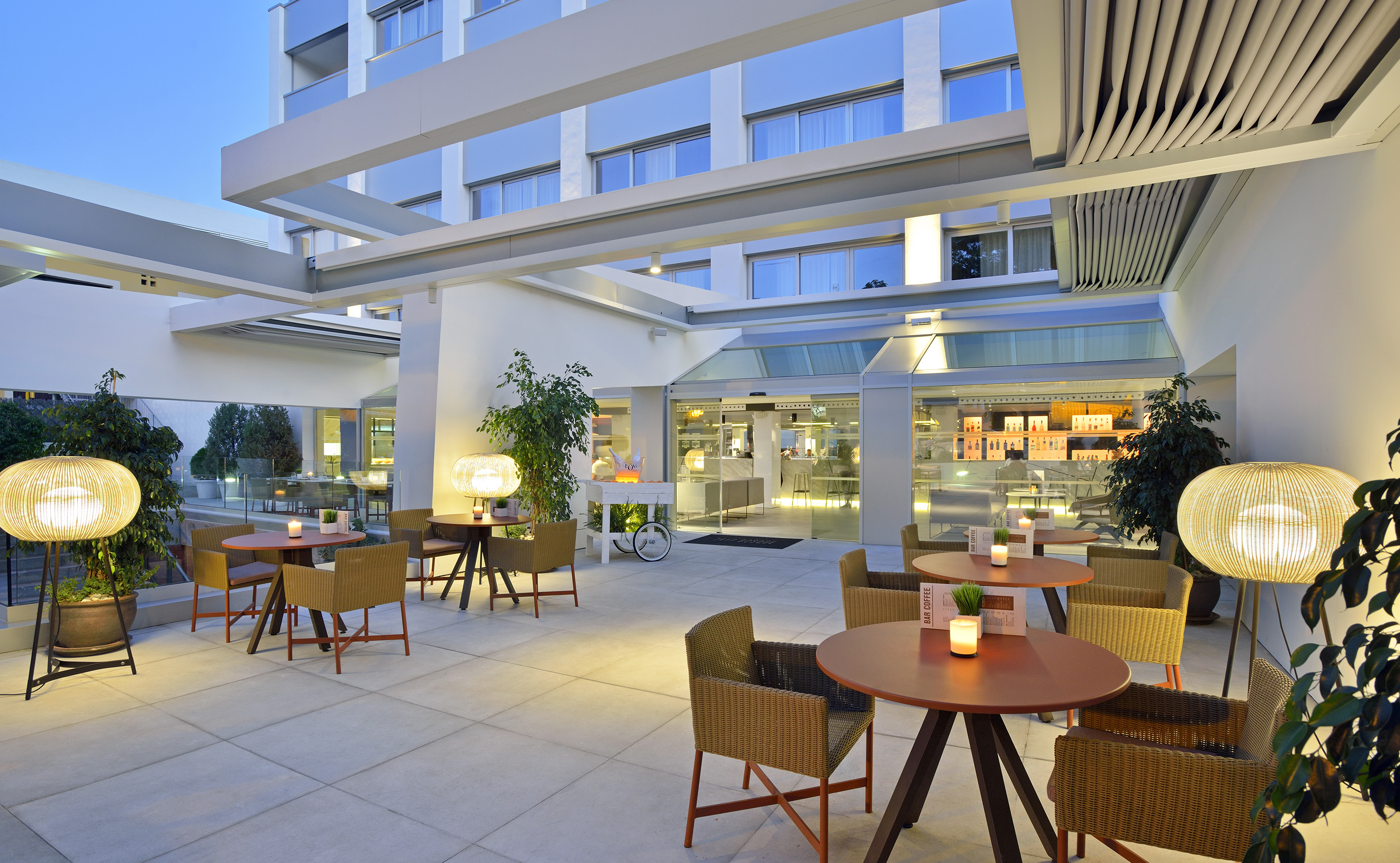 a patio with tables and chairs