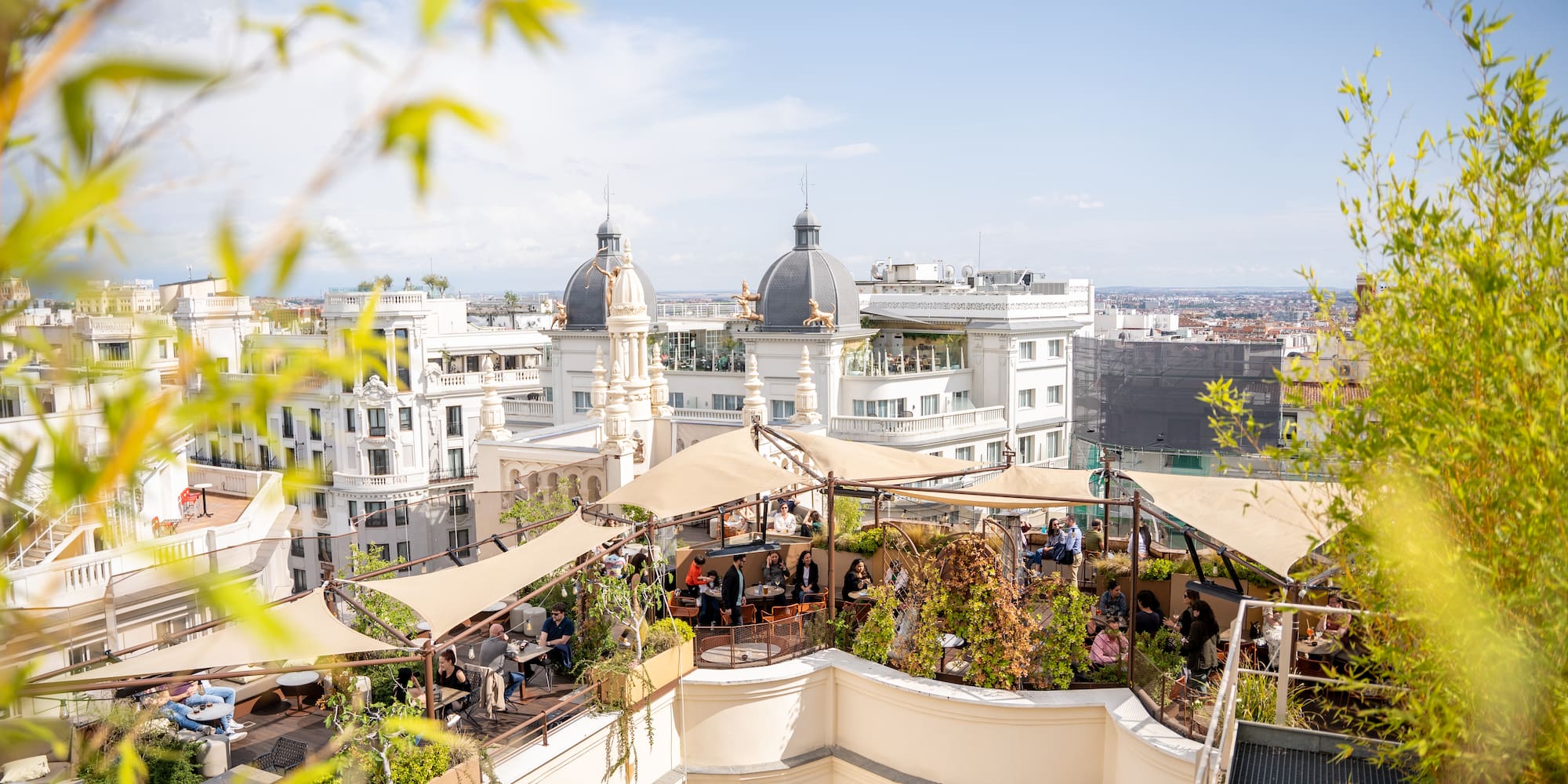 a rooftop patio with a group of people sitting on it