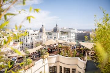 a rooftop patio with a group of people sitting on it