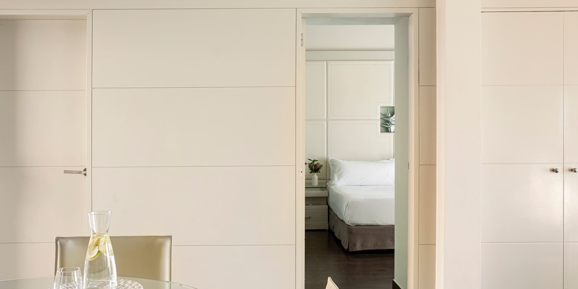 a room with a glass table and chairs