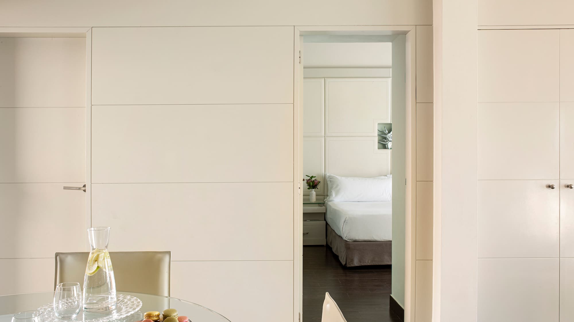 a room with a glass table and chairs