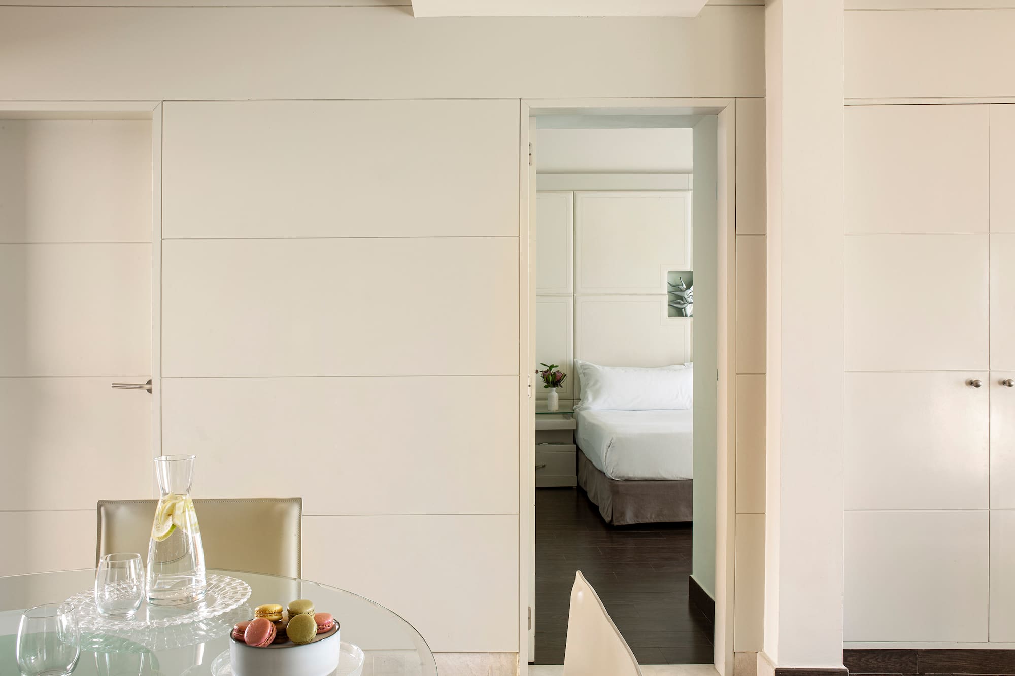 a room with a glass table and chairs