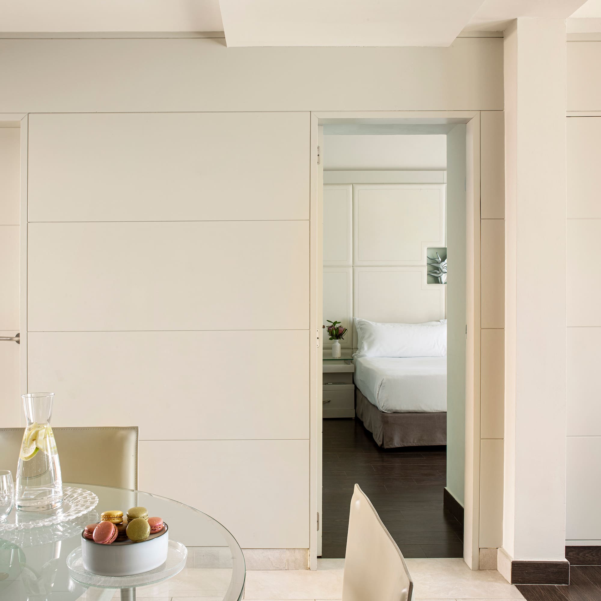 a room with a glass table and chairs