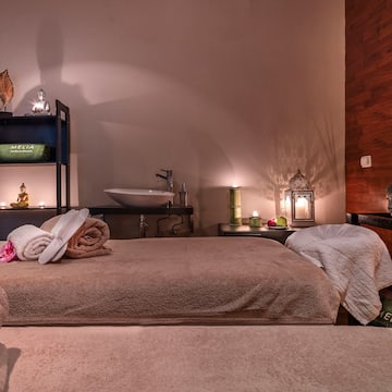 a room with a bed and towels