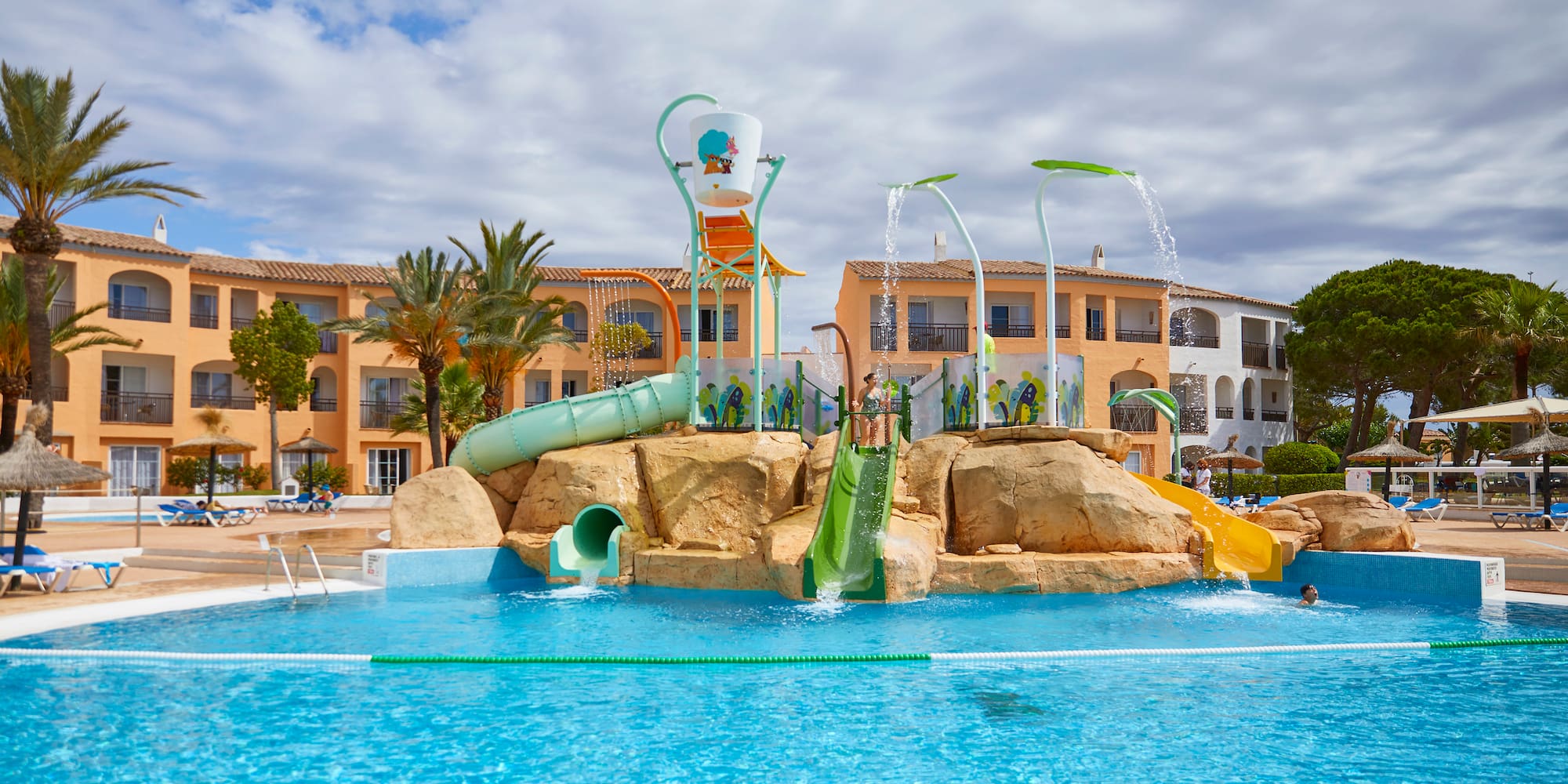 Hotel water park with slides, large pool, and resort buildings.