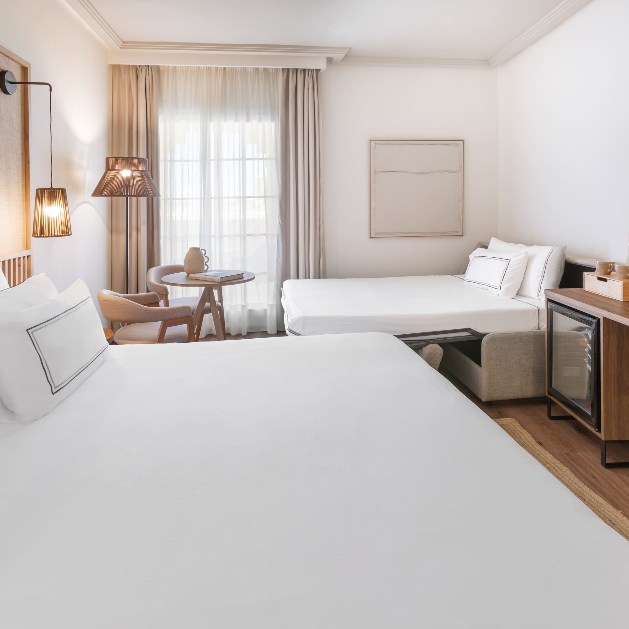 a room with two beds and a television