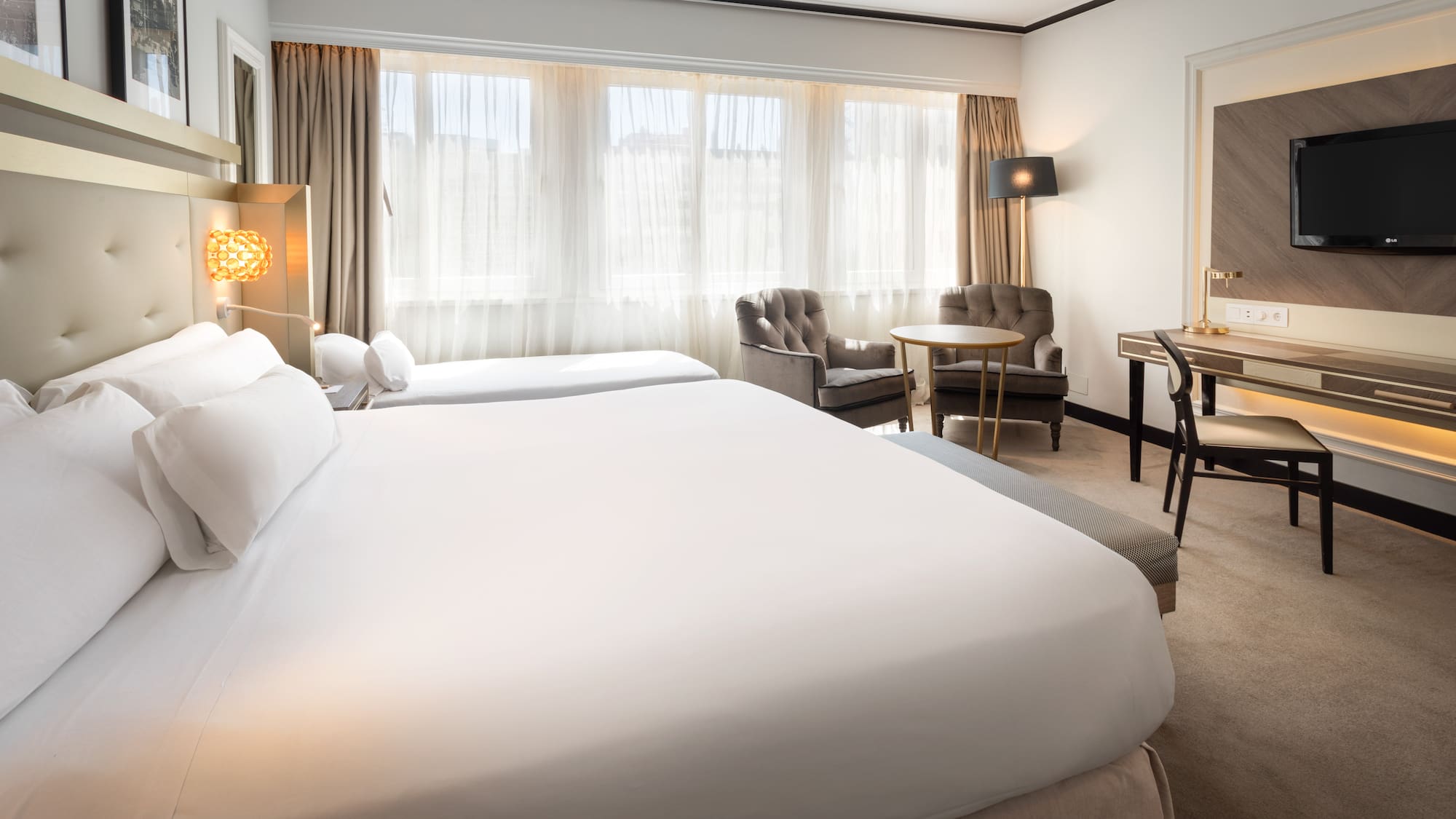 a hotel room with two beds and a table