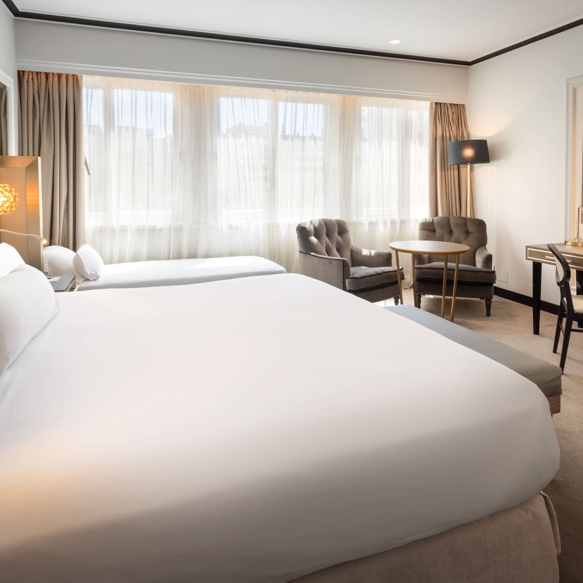 a hotel room with two beds and a table