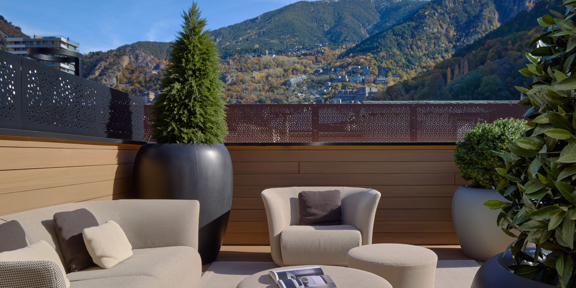 a patio with a view of mountains and trees