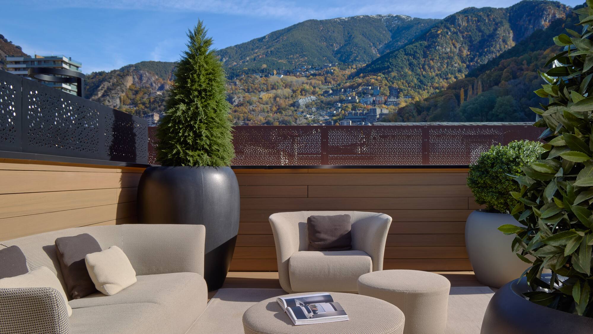 a patio with a view of mountains and trees