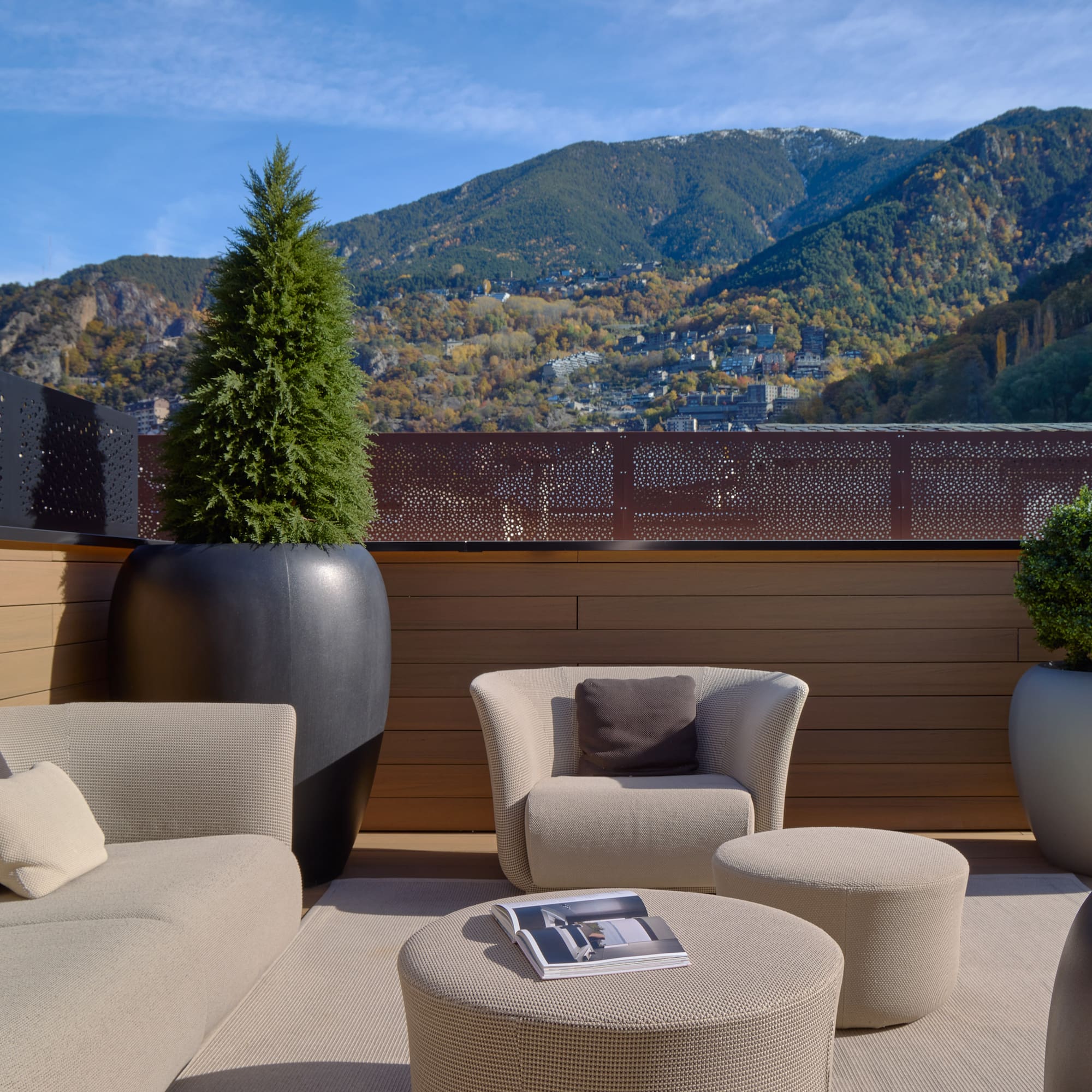 a patio with a view of mountains and trees