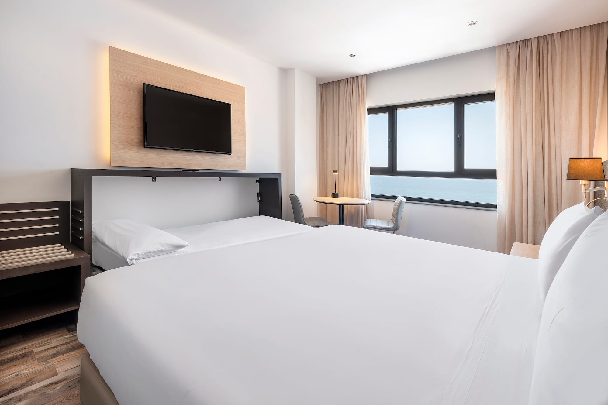 a room with a bed and a tv