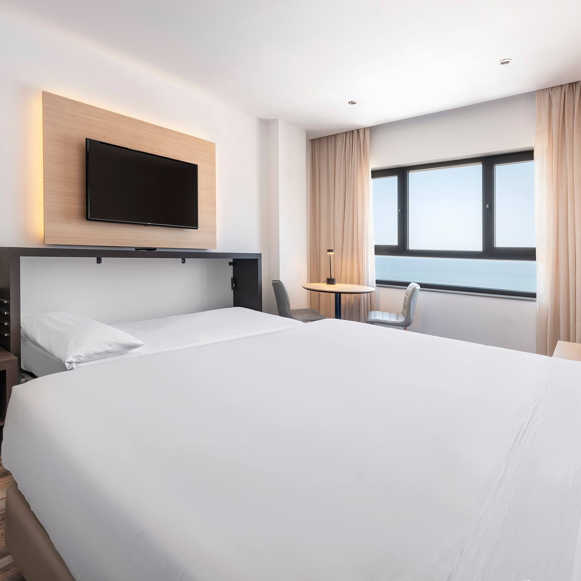 a room with a bed and a tv