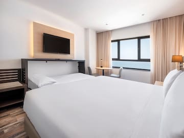 a room with a bed and a tv