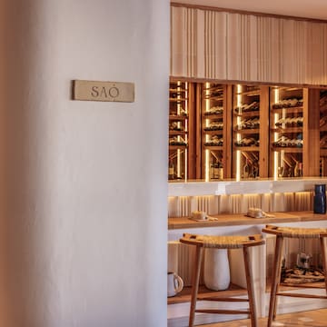 a wine cellar with shelves and stools