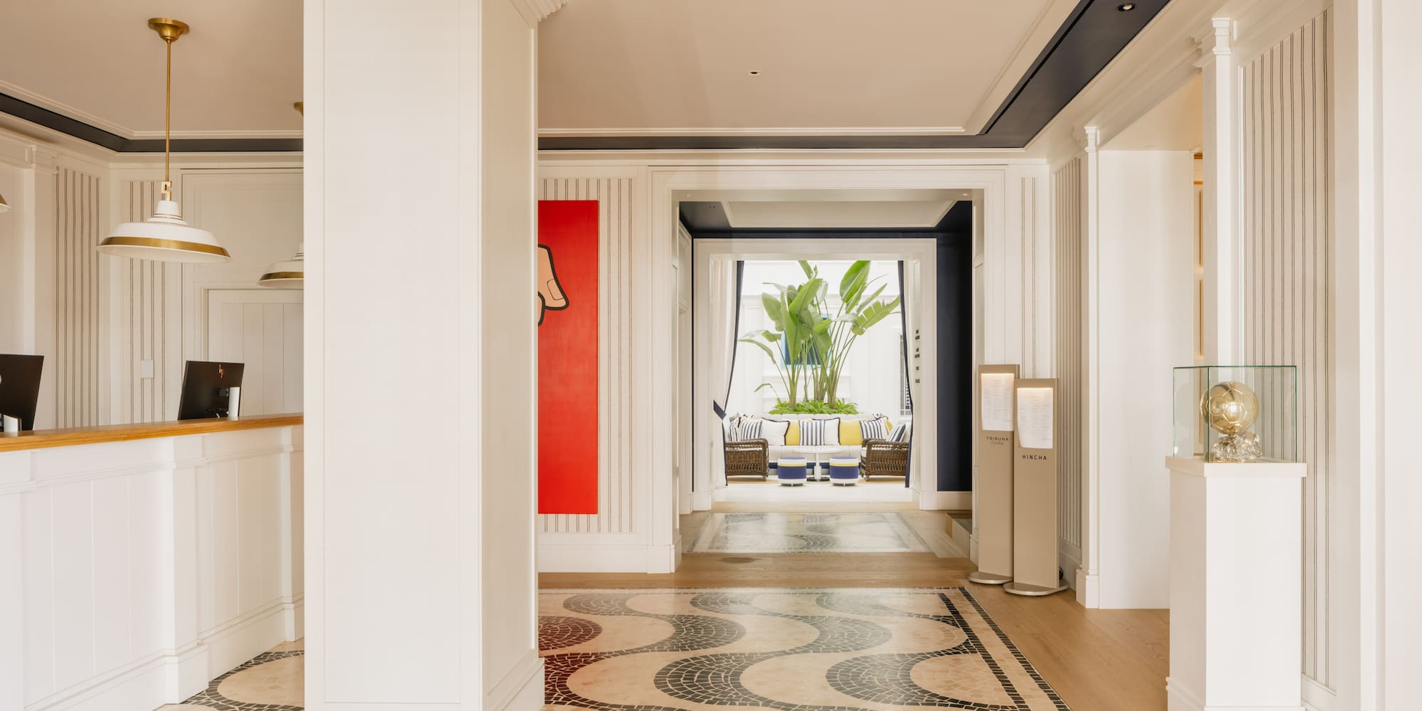 a hallway with a large white column