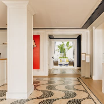 a hallway with a large white column