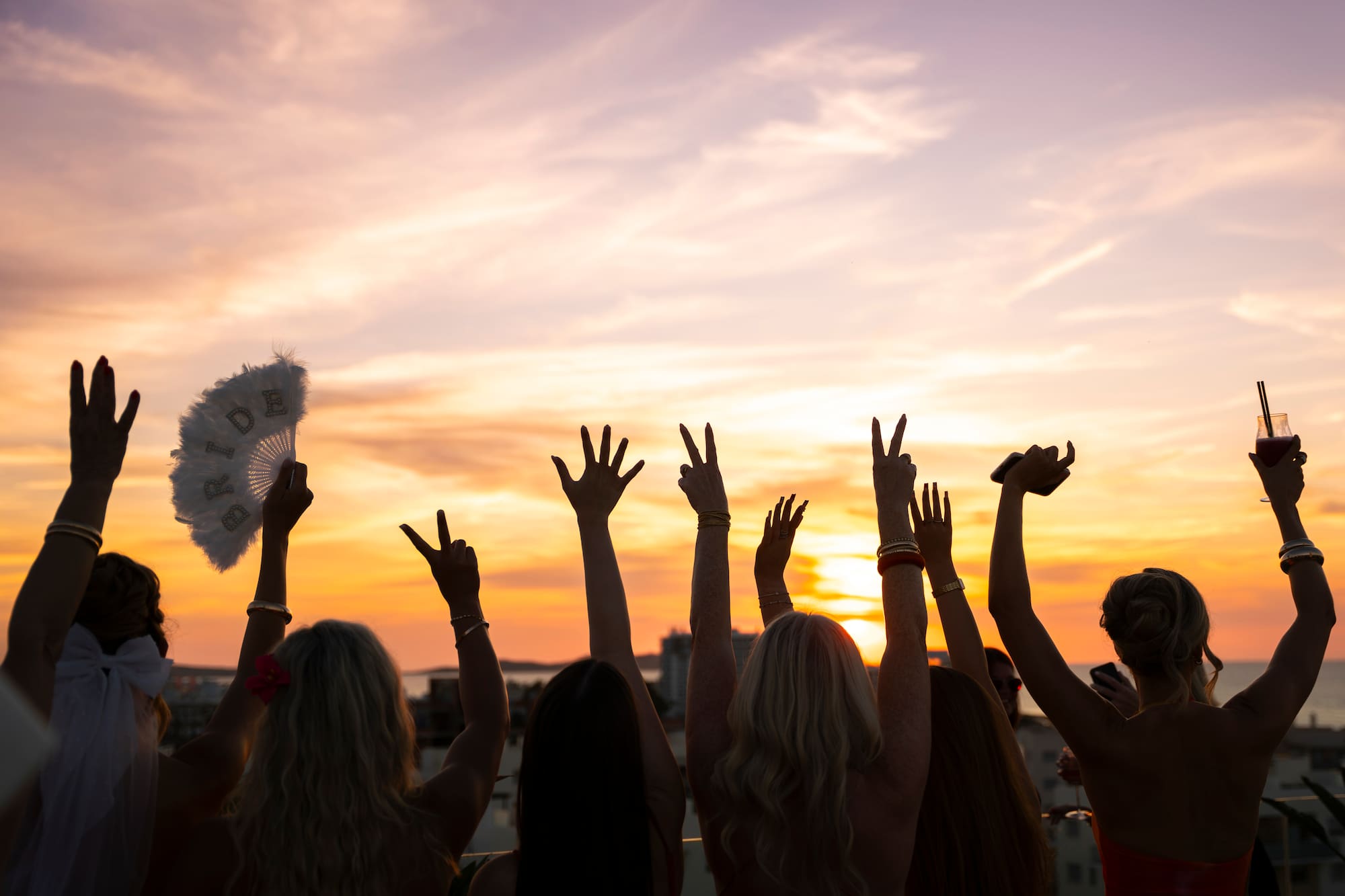 a group of people with their hands up in the air