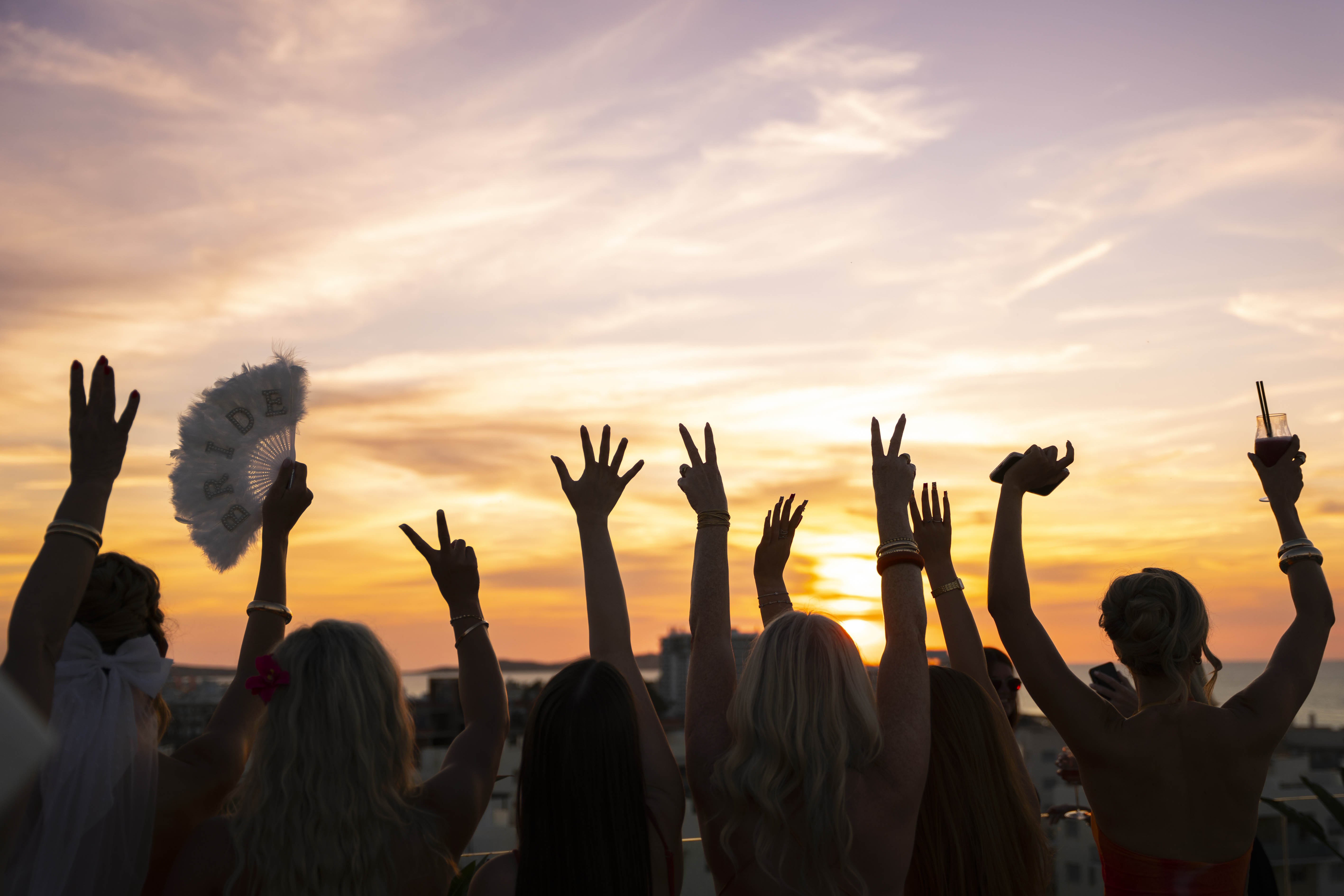 a group of people with their hands up in the air