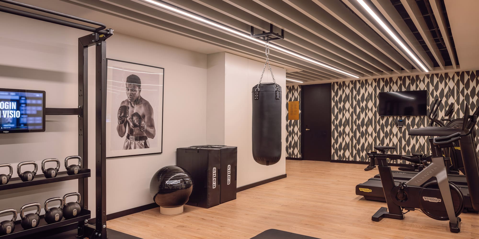 a gym with a punching bag and a picture of a boxer