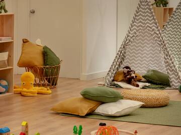 a room with a playroom with toys