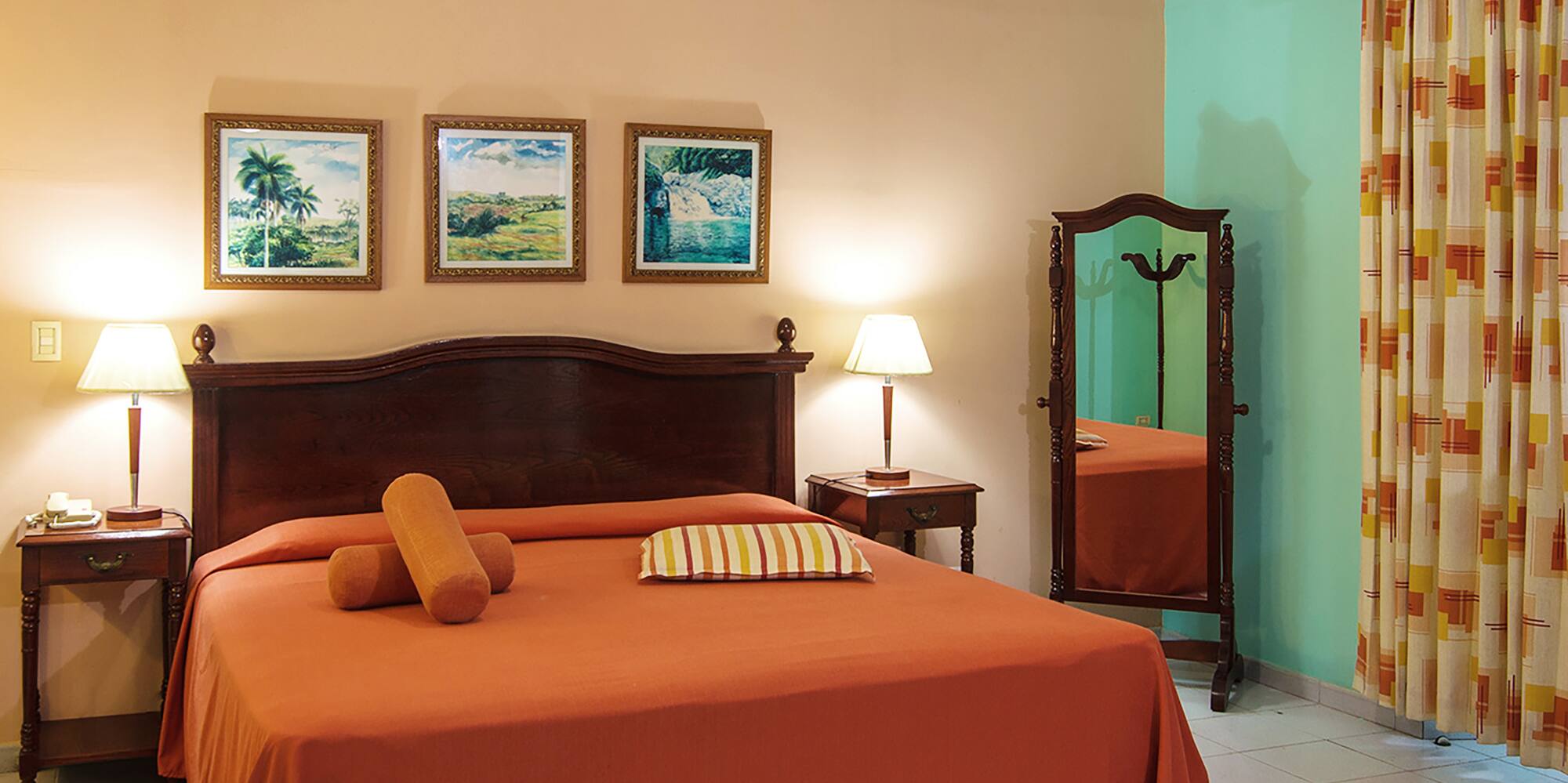 a bedroom with a bed and a mirror