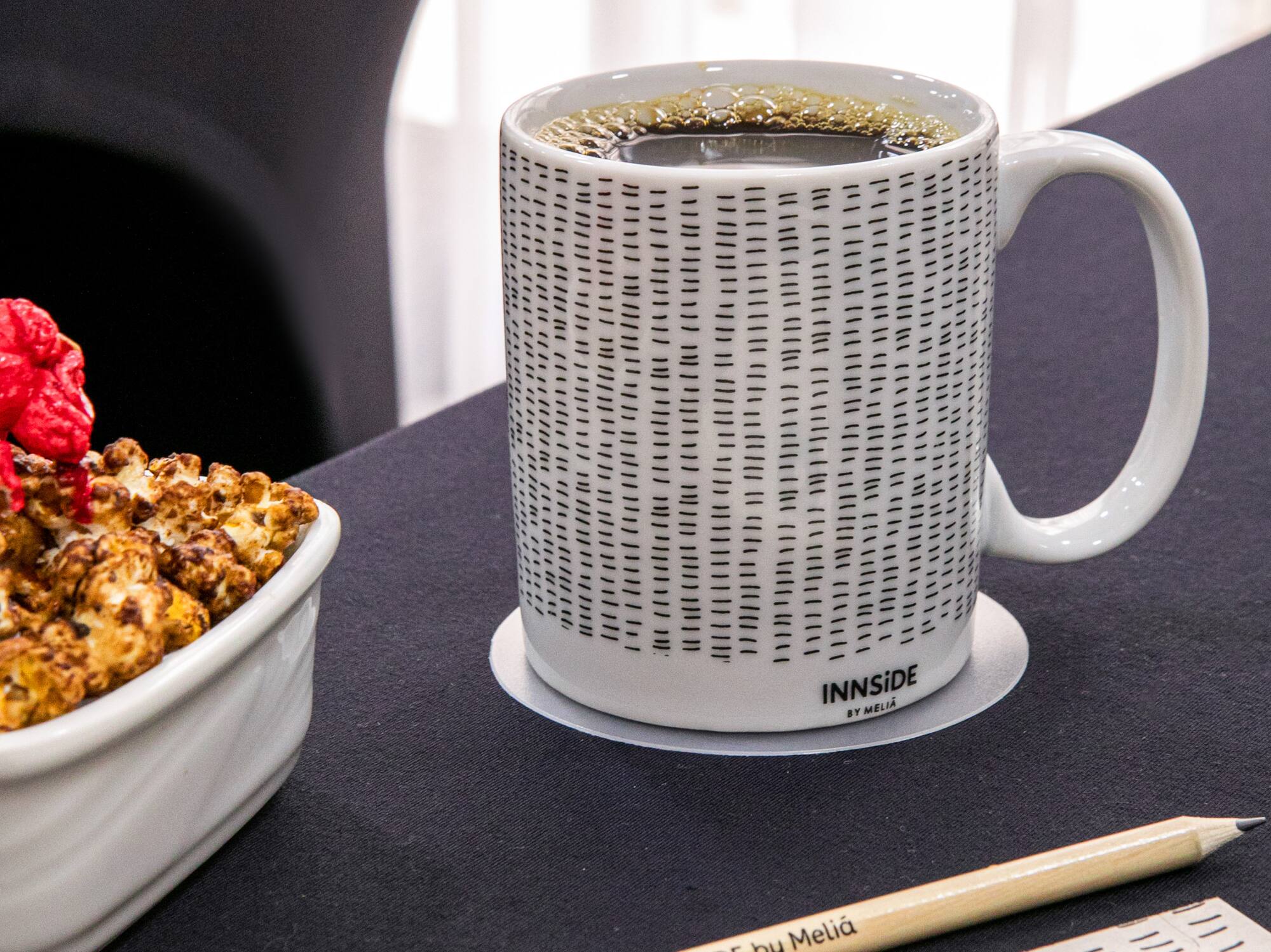 a cup of coffee and a bowl of popcorn