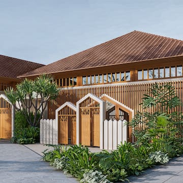 a building with a gate and trees