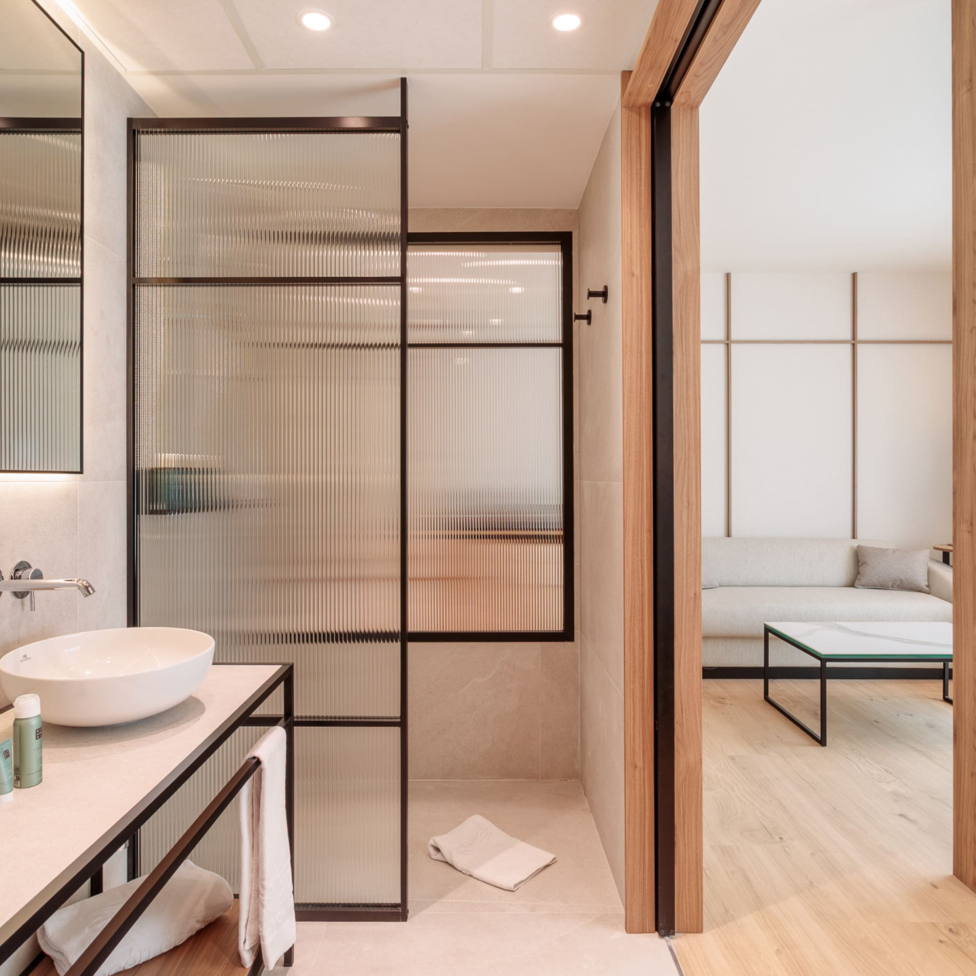 a bathroom with a glass shower door