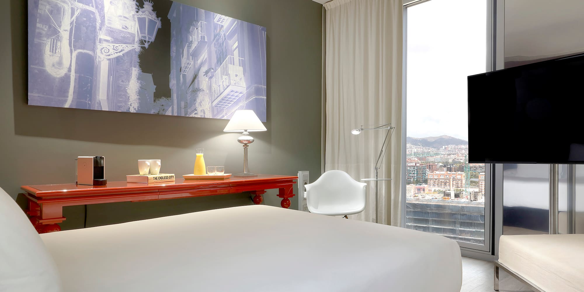 a bedroom with a large window and a large bed