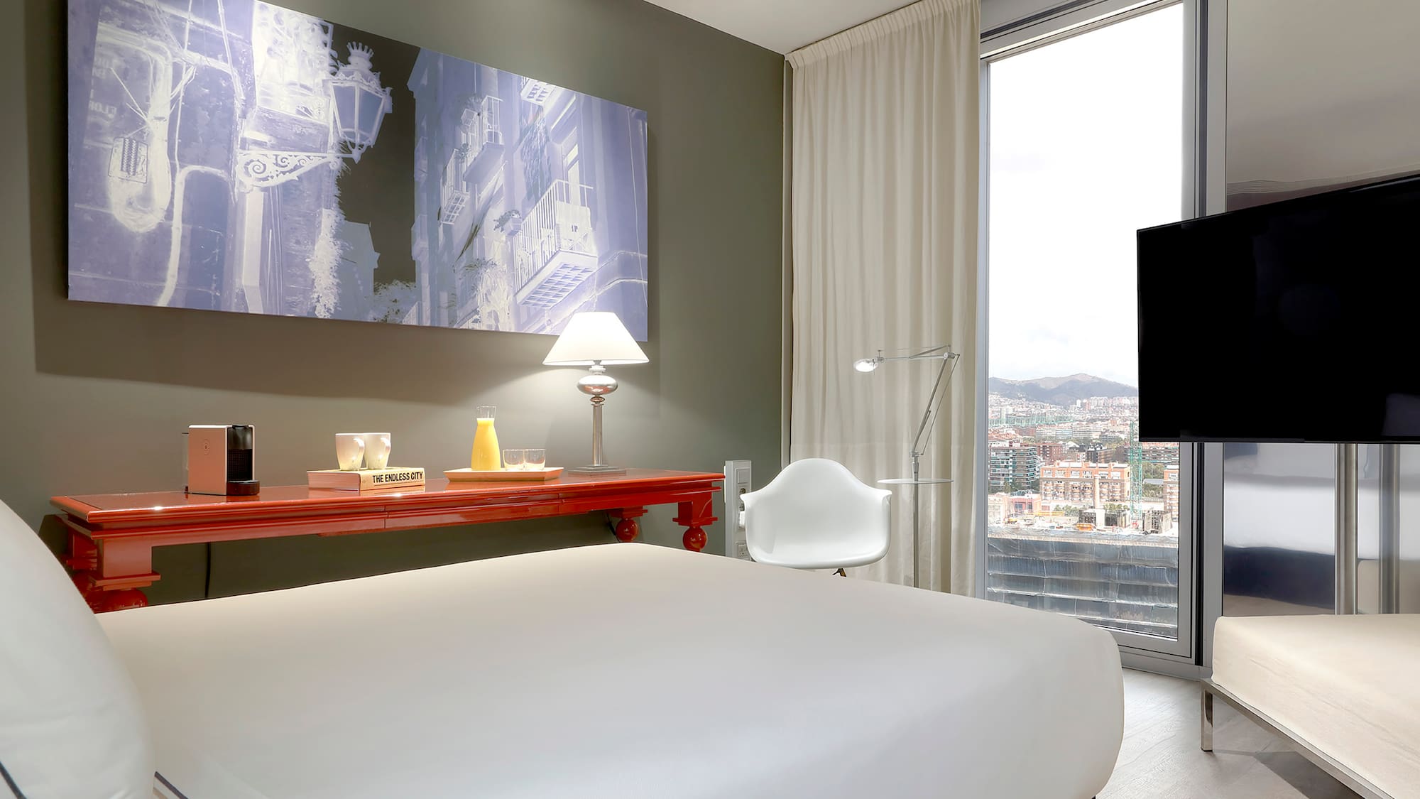 a bedroom with a large window and a large bed