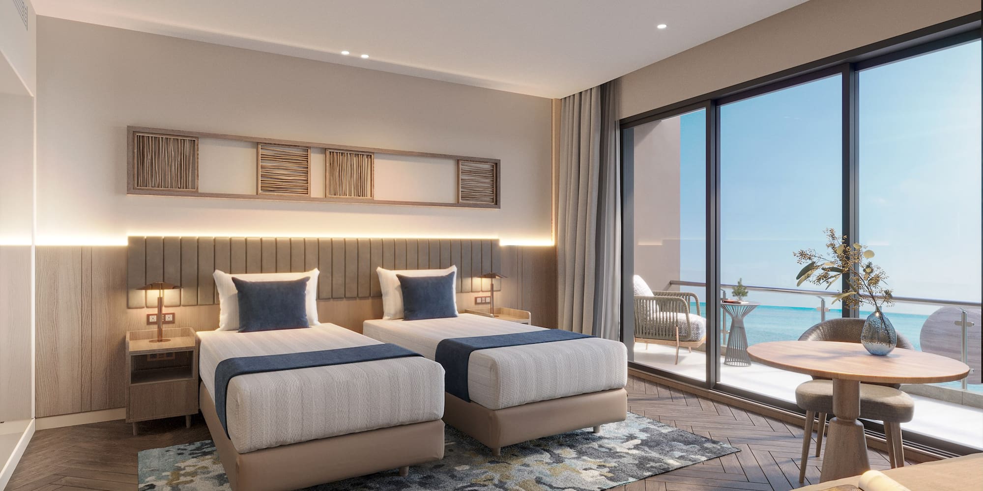 a room with two beds and a table and chairs